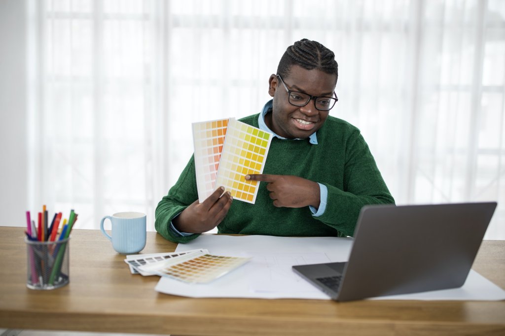 African American Man Designer Choosing Color Video Calling In Office