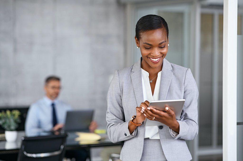 Black business woman using digital tablet in meeting room