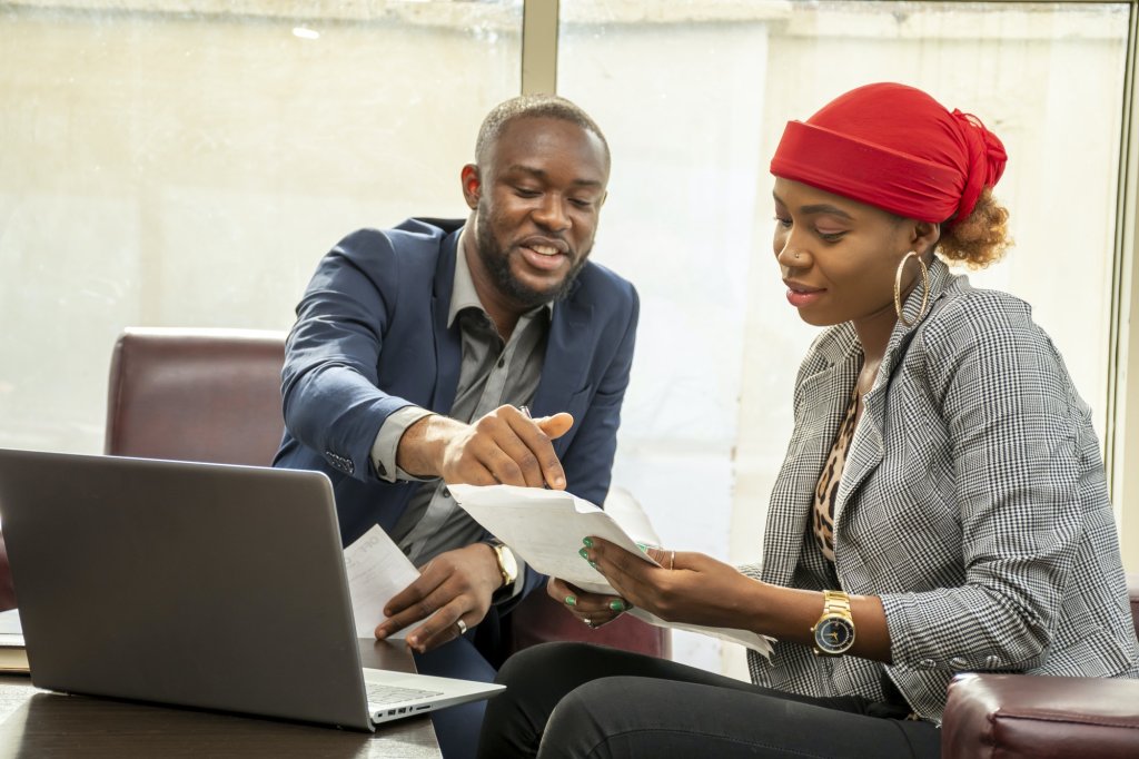 Young black business man and woman working together